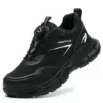 Compact black safety trainers with steel toe, slip-resistant sole, and breathable mesh lining. Zenith 907B