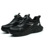 Compact black safety trainers with steel toe, slip-resistant sole, and breathable mesh lining. Zenith 907B
