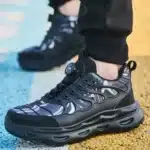 Black knob-lacing work trainers with steel toe, waterproof finish, and rugged outsole.