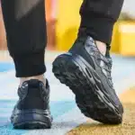 Black knob-lacing work trainers with steel toe, waterproof finish, and rugged outsole.1