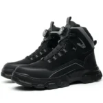 Black boots in a branded 9KSAFETYJB box, opened, on a wooden surface with tags and inserts neatly displayed.